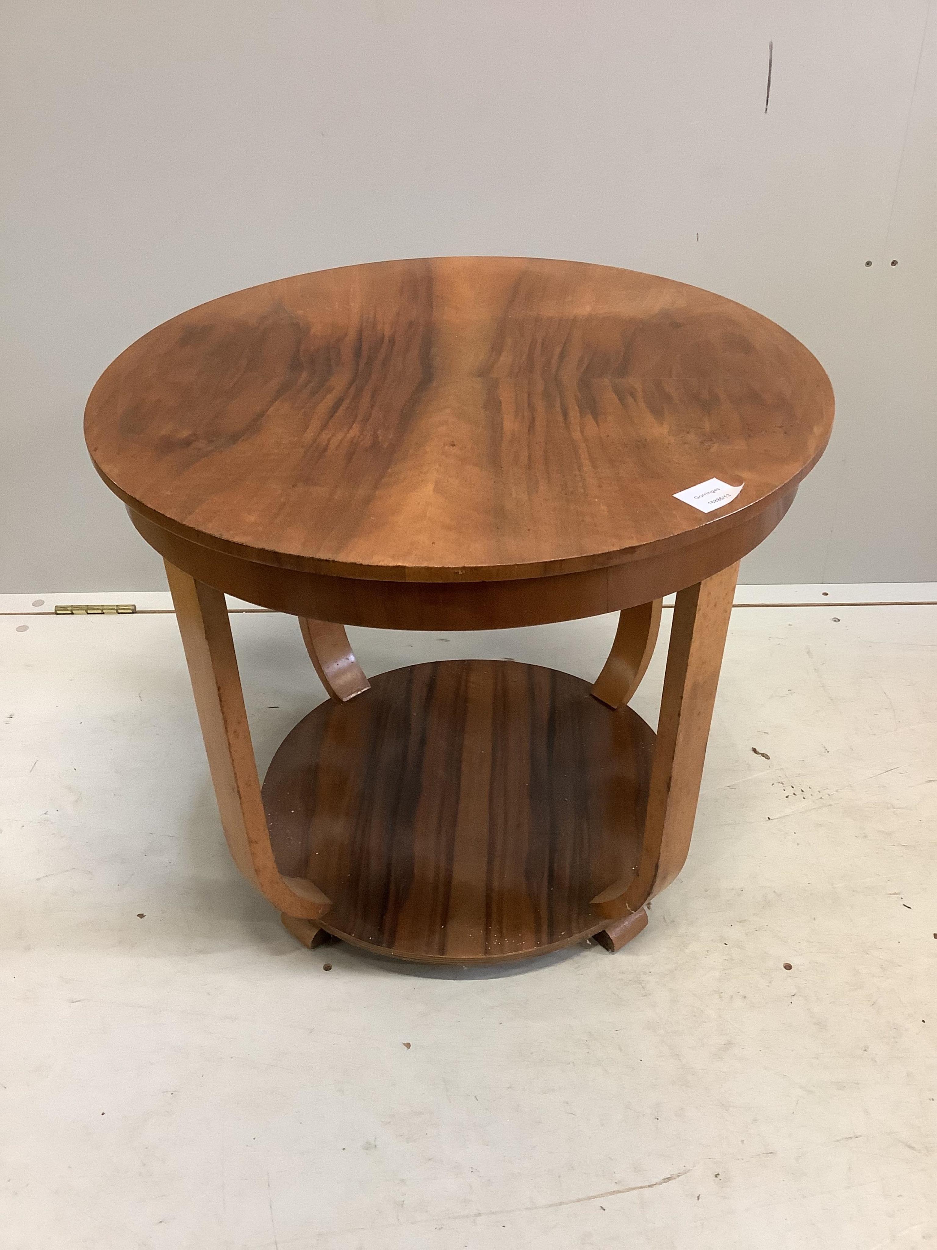 An Art Deco walnut circular two tier occasional table, diameter 60cm, height 52cm. Condition - fair